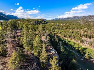 Experience breathtaking mountain views and lush pine forests from this stunning property.