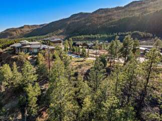 Experience unparalleled luxury in this stunning mountain estate, perched dramatically on a cliffside with breathtaking panoramic views.