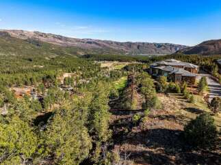 Experience luxury living with this stunning estate nestled amidst a picturesque mountain landscape.