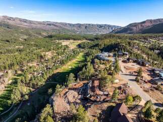 Experience luxury living in this stunning mountain estate, nestled amidst a pristine golf course and surrounded by majestic evergreen forests.