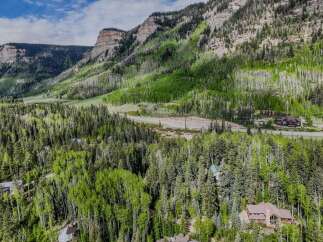 Nestled amidst a lush forest and towering mountains, this property offers a serene escape with breathtaking natural beauty.