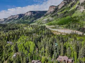 Nestled amidst a lush forest of aspen and pine trees, this property offers a serene mountain retreat.