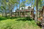 Nestled amongst mature aspen trees, this charming log home offers a serene retreat with its rustic architecture and picturesque setting.