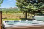 Relax and unwind in this luxurious hot tub, offering breathtaking views of snow-capped mountains and lush green valleys.