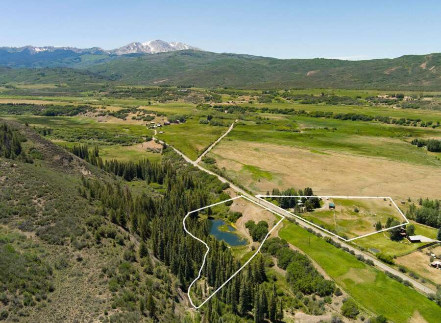 Discover this expansive property offering a picturesque setting with a serene pond and lush greenery.