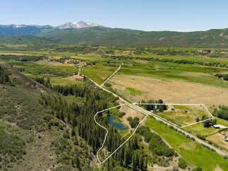 Discover this expansive property offering a picturesque setting with a serene pond and lush greenery.