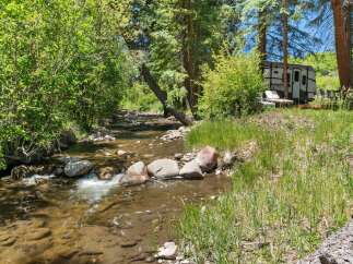 Experience serene living with this charming property nestled beside a babbling creek.