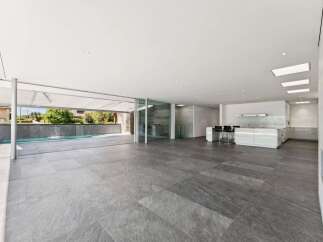 Experience modern luxury in this spacious open-concept living area, seamlessly blending indoor and outdoor living.