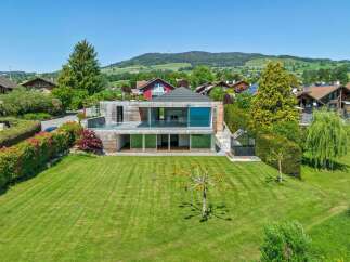 Experience modern luxury in this stunning architectural home, featuring expansive glass walls and a sleek, minimalist design.