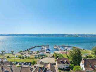 Experience lakeside living with this stunning property offering panoramic views of the serene blue waters and a picturesque marina.