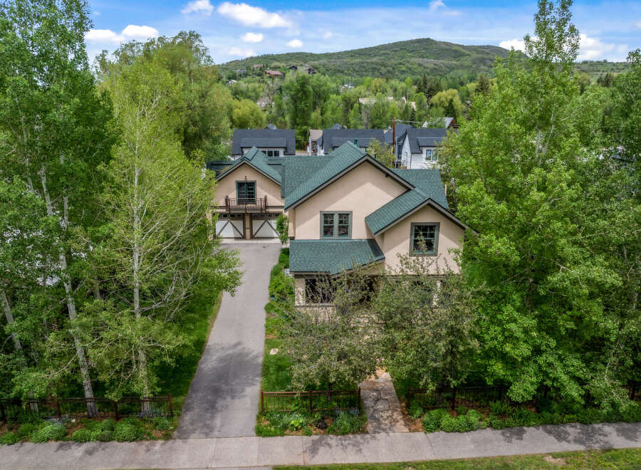 Nestled amidst lush greenery and mature trees, this charming home offers a serene mountain retreat.