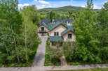 Nestled amidst lush greenery and mature trees, this charming home offers a serene mountain retreat.