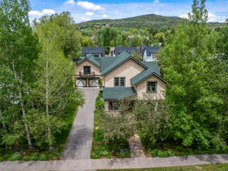 Nestled amidst lush greenery and mature trees, this charming home offers a serene mountain retreat.
