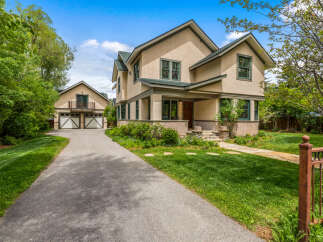 Charming home with a welcoming front porch and a detached garage.