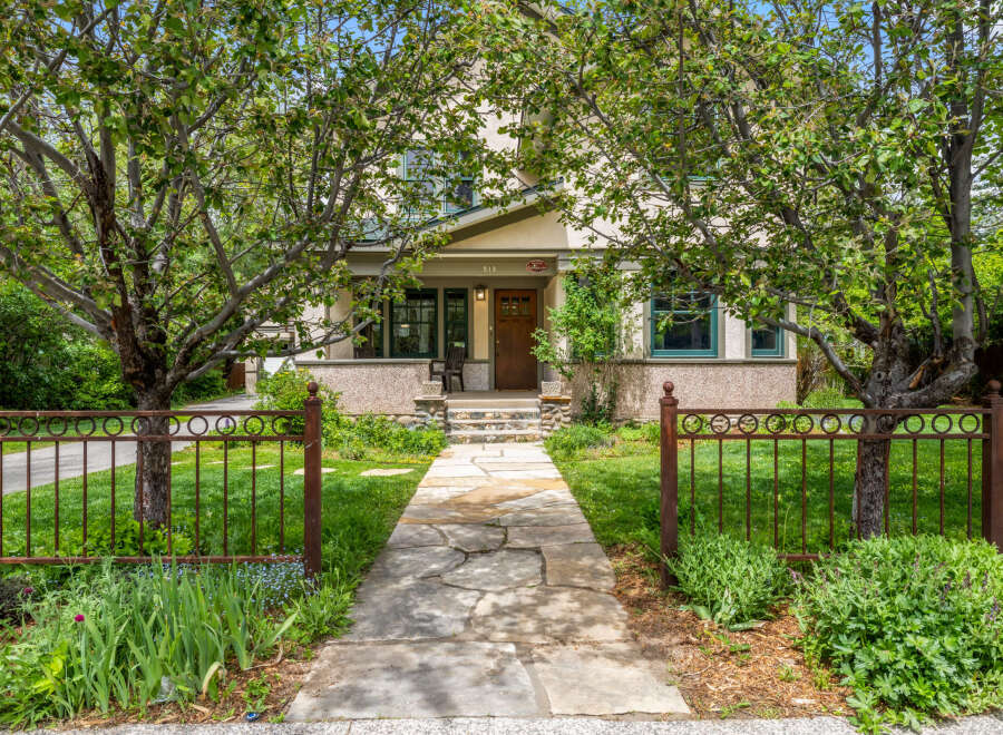 Charming craftsman home with a welcoming stone pathway leading to the front porch.