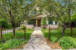 Charming craftsman home with a welcoming stone pathway leading to the front porch.