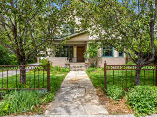 Charming craftsman home with a welcoming stone pathway leading to the front porch.