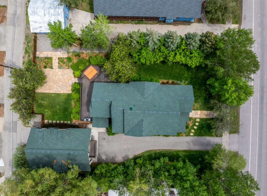 Discover this charming property featuring a spacious main house with a durable green shingle roof, complemented by a separate guest house.