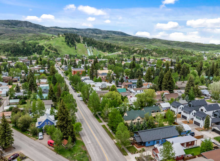 Discover this charming mountain town home, nestled amidst lush greenery and offering stunning views of the surrounding hills and ski slopes.