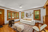 Step into this inviting living room featuring a plush white sofa adorned with accent pillows, perfect for relaxation.