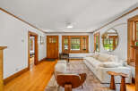 Step into this inviting living room featuring a plush white sectional sofa complemented by a textured rug and unique wooden side tables.