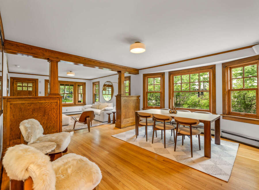 Experience the charm of this beautifully appointed dining and living area, featuring rich wood accents and abundant natural light.