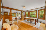 Experience the charm of this beautifully appointed dining and living area, featuring rich wood accents and abundant natural light.