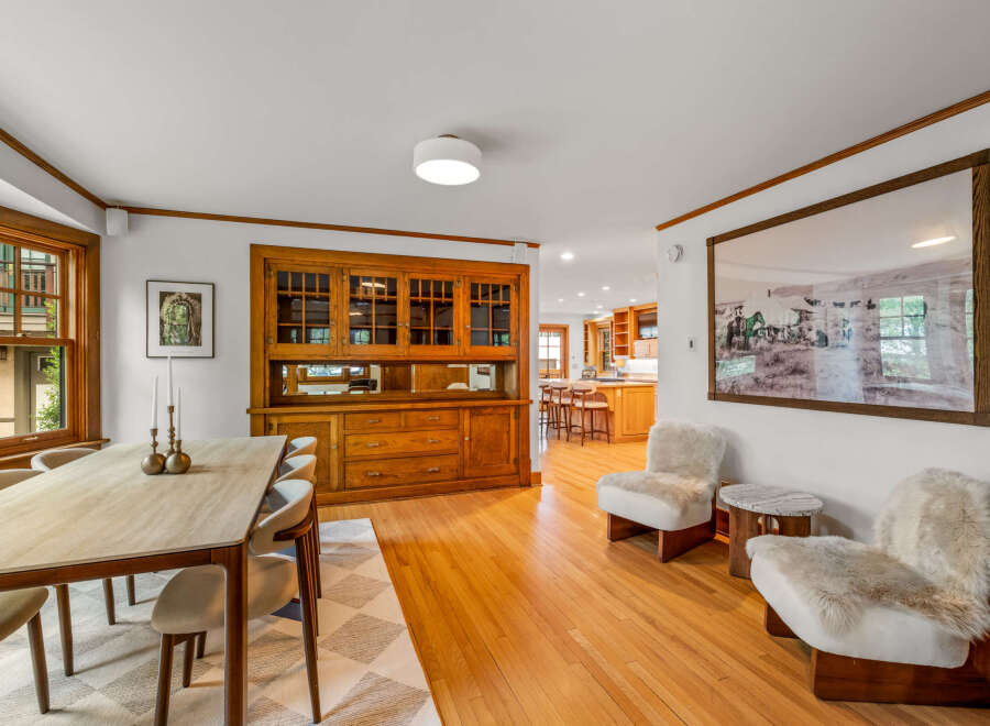 Experience elegant dining in this beautifully appointed space, featuring a large wooden hutch with glass-front cabinets and ample storage.