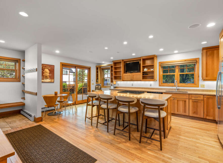This spacious kitchen boasts a large island with seating, perfect for casual dining and entertaining.