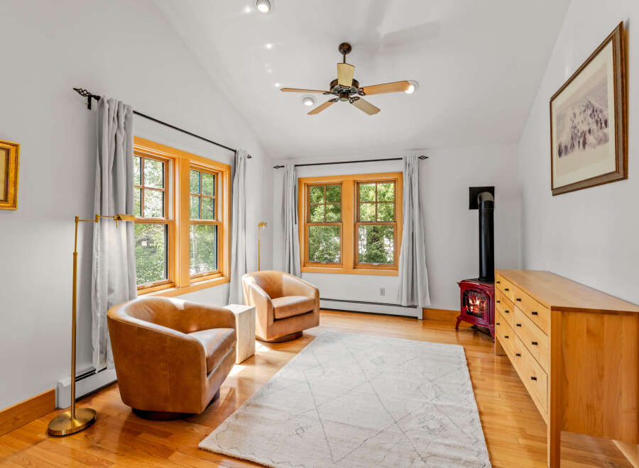 Cozy living room featuring a wood-burning stove with a vibrant red finish, perfect for chilly evenings.
