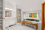 Indulge in luxury in this stunning bathroom featuring a deep soaking tub with elegant gold fixtures, perfect for unwinding.