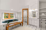 Indulge in luxury in this stunning bathroom featuring a deep soaking tub with elegant brass fixtures, perfect for unwinding.