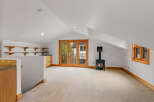 This charming attic space features a cozy wood-burning stove, perfect for chilly evenings.