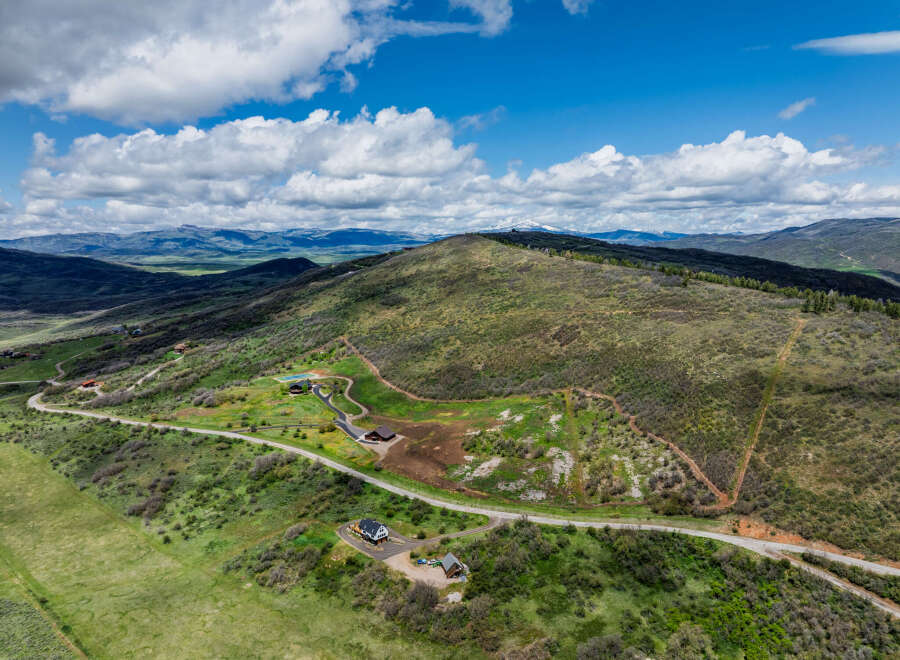 Discover your dream mountain retreat with this stunning aerial view of a sprawling property.