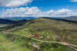 Discover your dream mountain retreat with this stunning aerial view of a sprawling property.