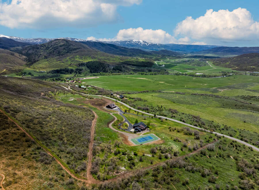 Experience luxury mountain living with this stunning estate featuring a modern home, private tennis court, and expansive grounds.