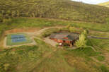 Experience luxury mountain living in this stunning property featuring a spacious home with a private tennis court.