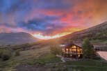 Experience luxury mountain living in this stunning home, perfectly situated to capture breathtaking sunset views.