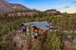 Experience luxury mountain living in this stunning contemporary home, nestled amidst towering pines and dramatic rock formations.