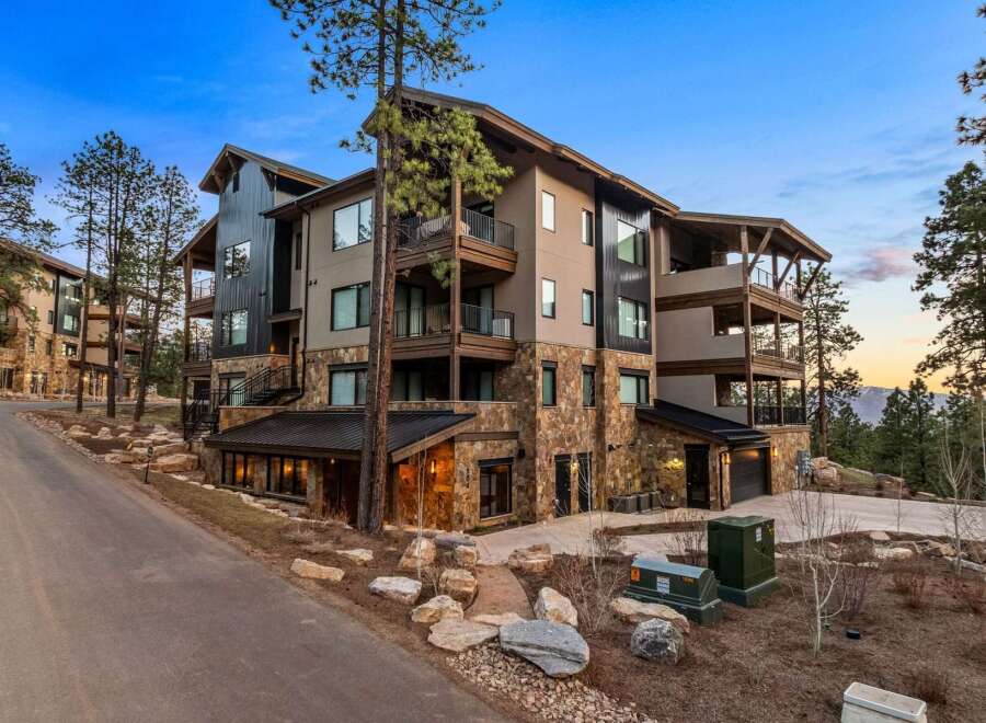 Experience luxury mountain living in this stunning multi-story residence, featuring a striking blend of stone and modern siding.