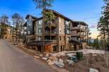 Experience luxury mountain living in this stunning multi-story residence, featuring a striking blend of stone and modern siding.