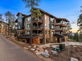 Experience luxury mountain living in this stunning multi-story residence, featuring a striking blend of stone and modern siding.