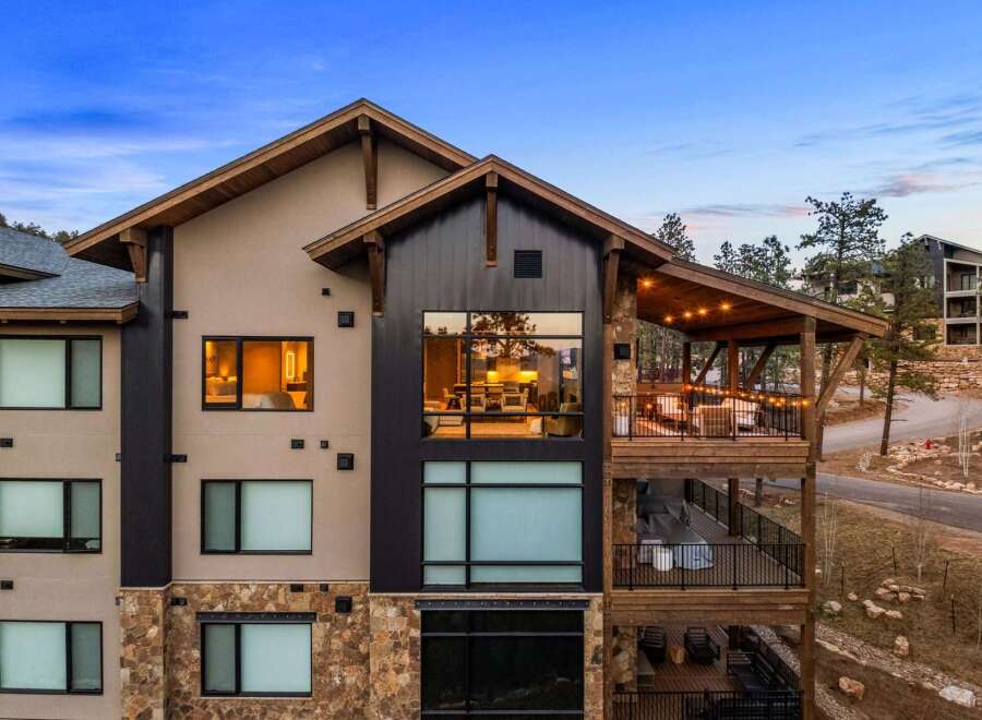 Experience luxury mountain living in this stunning property, featuring expansive windows that showcase breathtaking natural views.