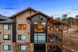 Experience luxury mountain living in this stunning property, featuring expansive windows that showcase breathtaking natural views.