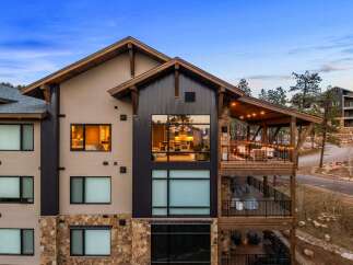 Experience luxury mountain living in this stunning property, featuring expansive windows that showcase breathtaking natural views.