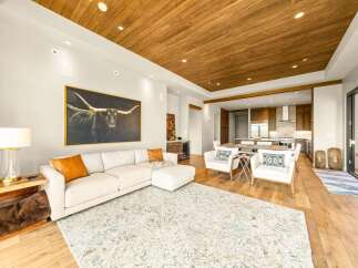 Experience luxurious open-concept living with a stunning longhorn artwork as the centerpiece of this spacious living area.