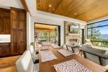 Experience luxury mountain living in this stunning home featuring a spacious dining area with a rustic wooden table and elegant placemats.