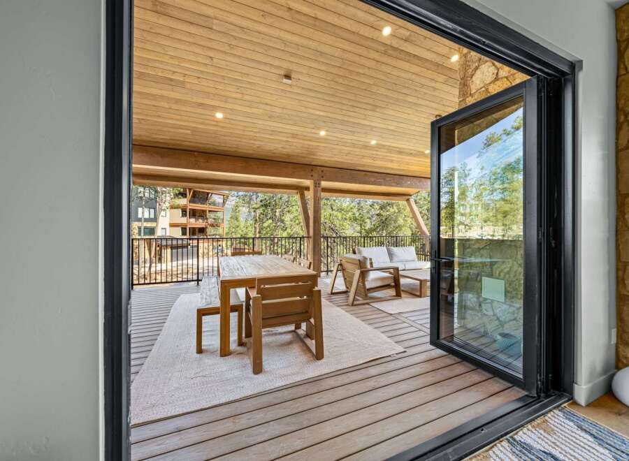 Experience seamless indoor-outdoor living with this stunning covered deck, perfect for entertaining or relaxing amidst breathtaking natural surroundings.