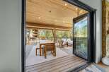 Experience seamless indoor-outdoor living with this stunning covered deck, perfect for entertaining or relaxing amidst breathtaking natural surroundings.