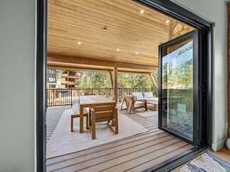 Experience seamless indoor-outdoor living with this stunning covered deck, perfect for entertaining or relaxing amidst breathtaking natural surroundings.
